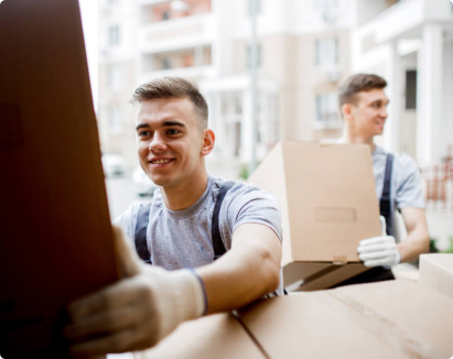 two movers holding boxes for man with a van services